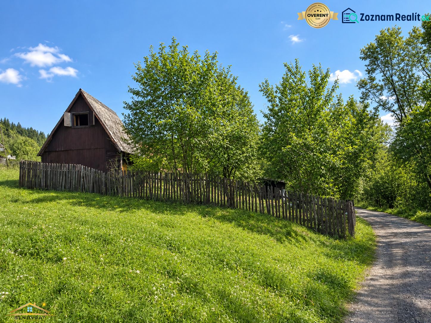 Wooden cottage with a fence on a plot of land near the forest in Radôstka.