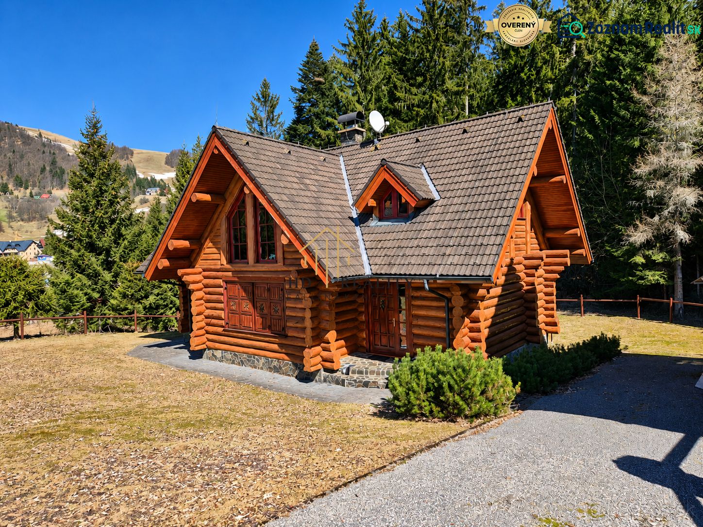 A wooden cabin in Banská Bystrica surrounded by mountains and forests.