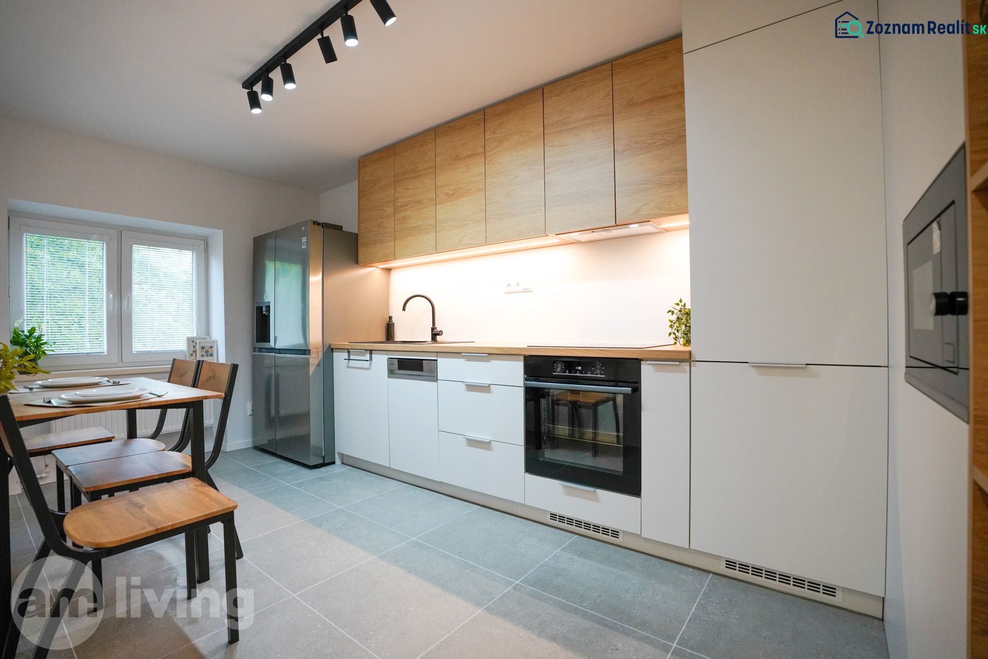 A kitchen in a 3-room apartment with a wooden decor and white cabinets.