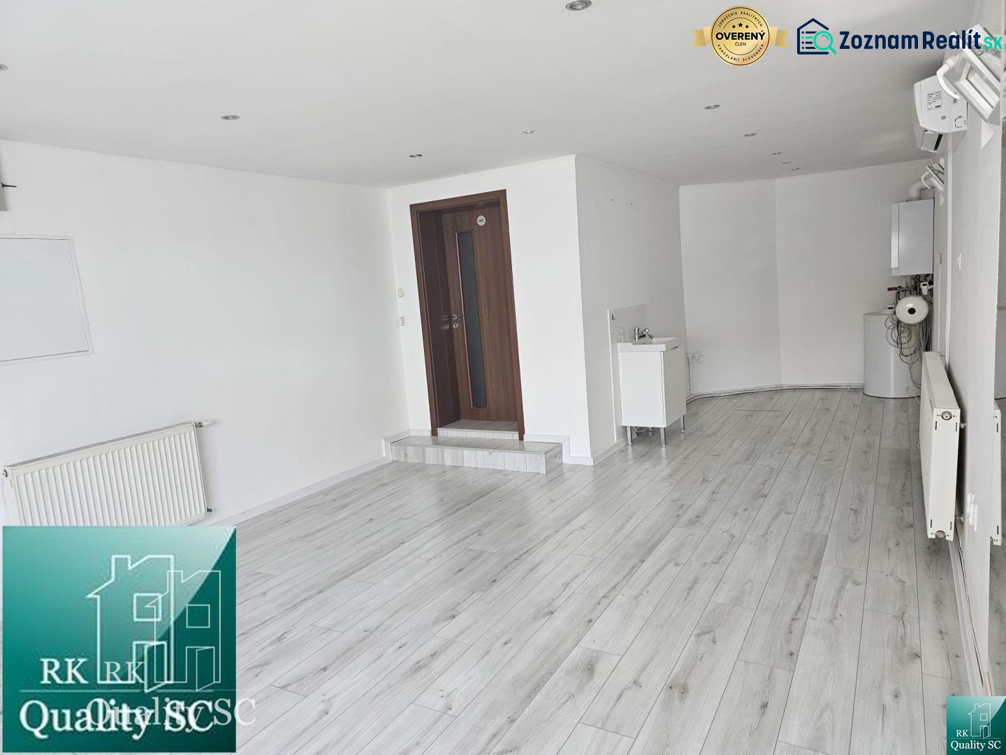 Commercial spaces with white walls and wood-patterned flooring.