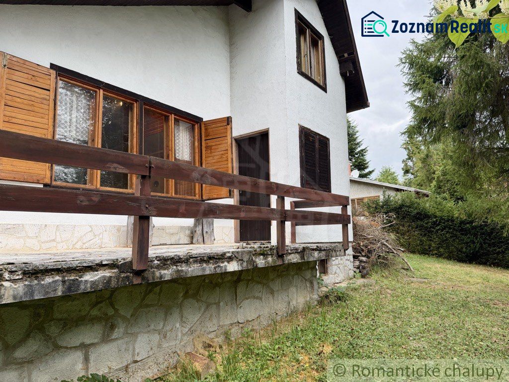A cottage in Košická Belá with wooden shutters and a stone base.