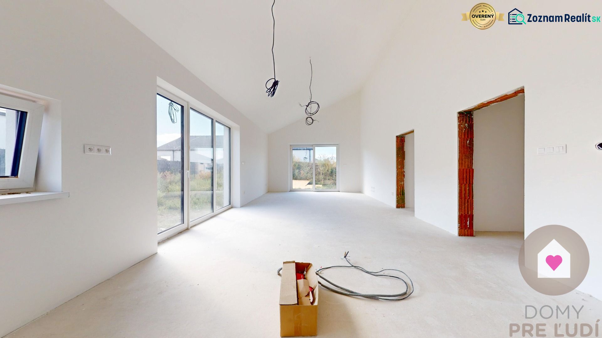 The interior of a family house with white walls and large windows.