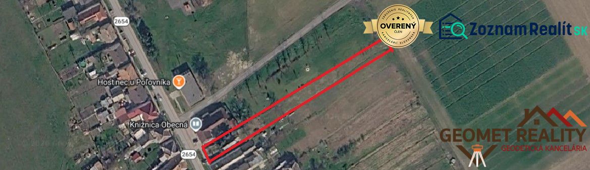 Aerial photograph of the land in Mikušovce, next to the main road and buildings.