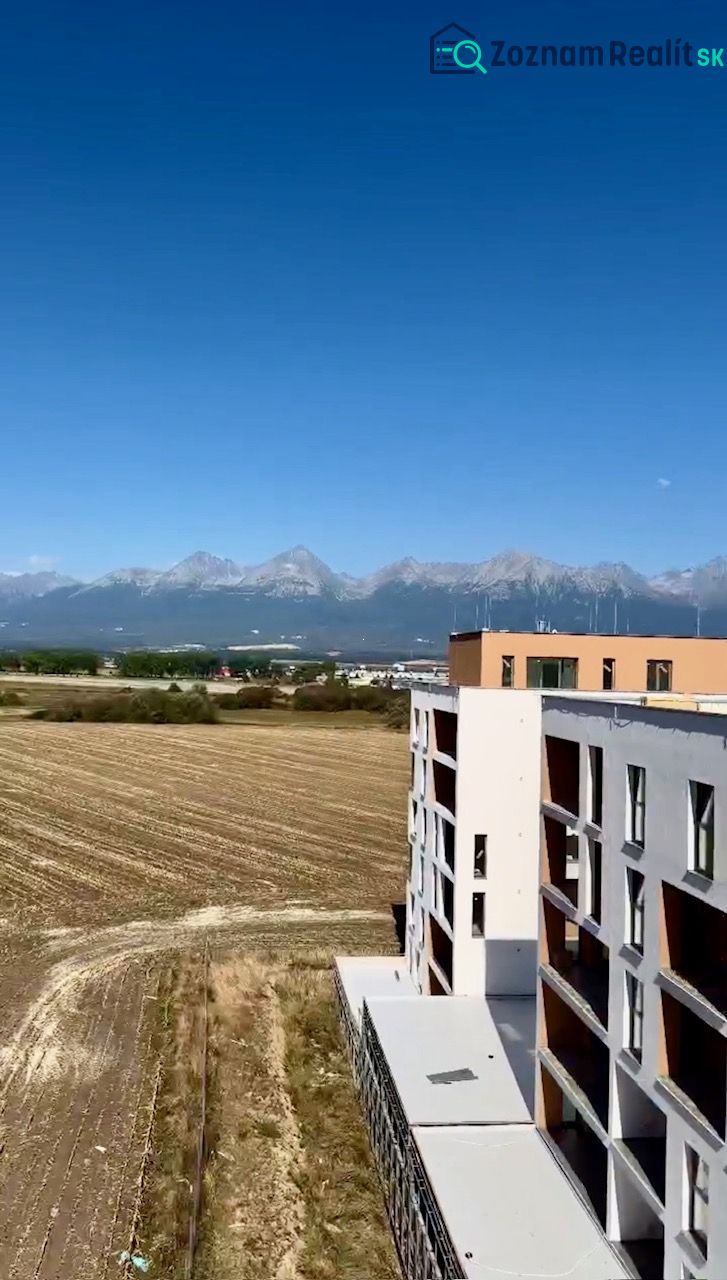 View of the mountains and a building from Suchoňova Street in Poprad, ideal for a 4-room apartment.