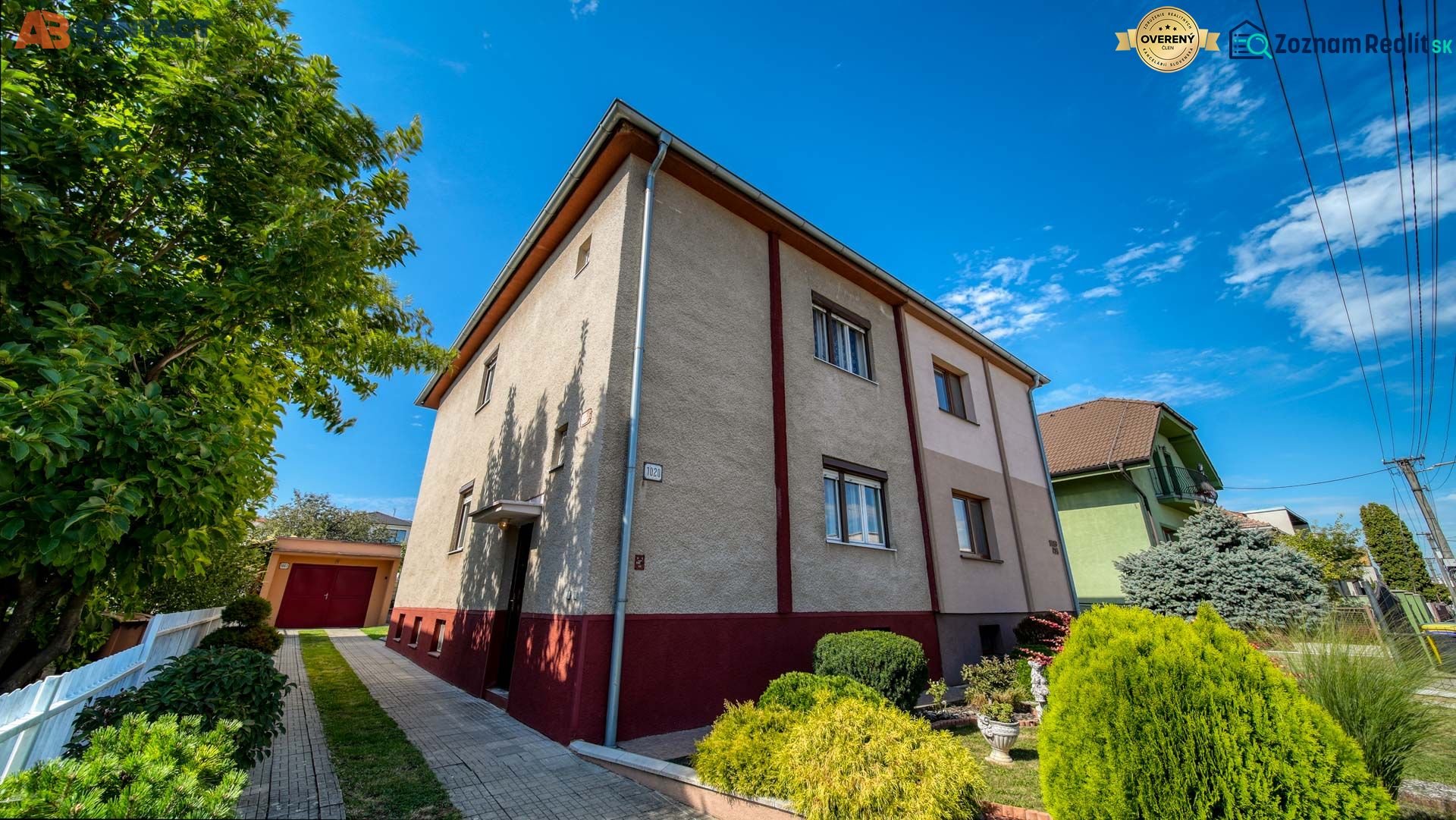 A family house on Sadova Street in Vrbové surrounded by trees and flowers.