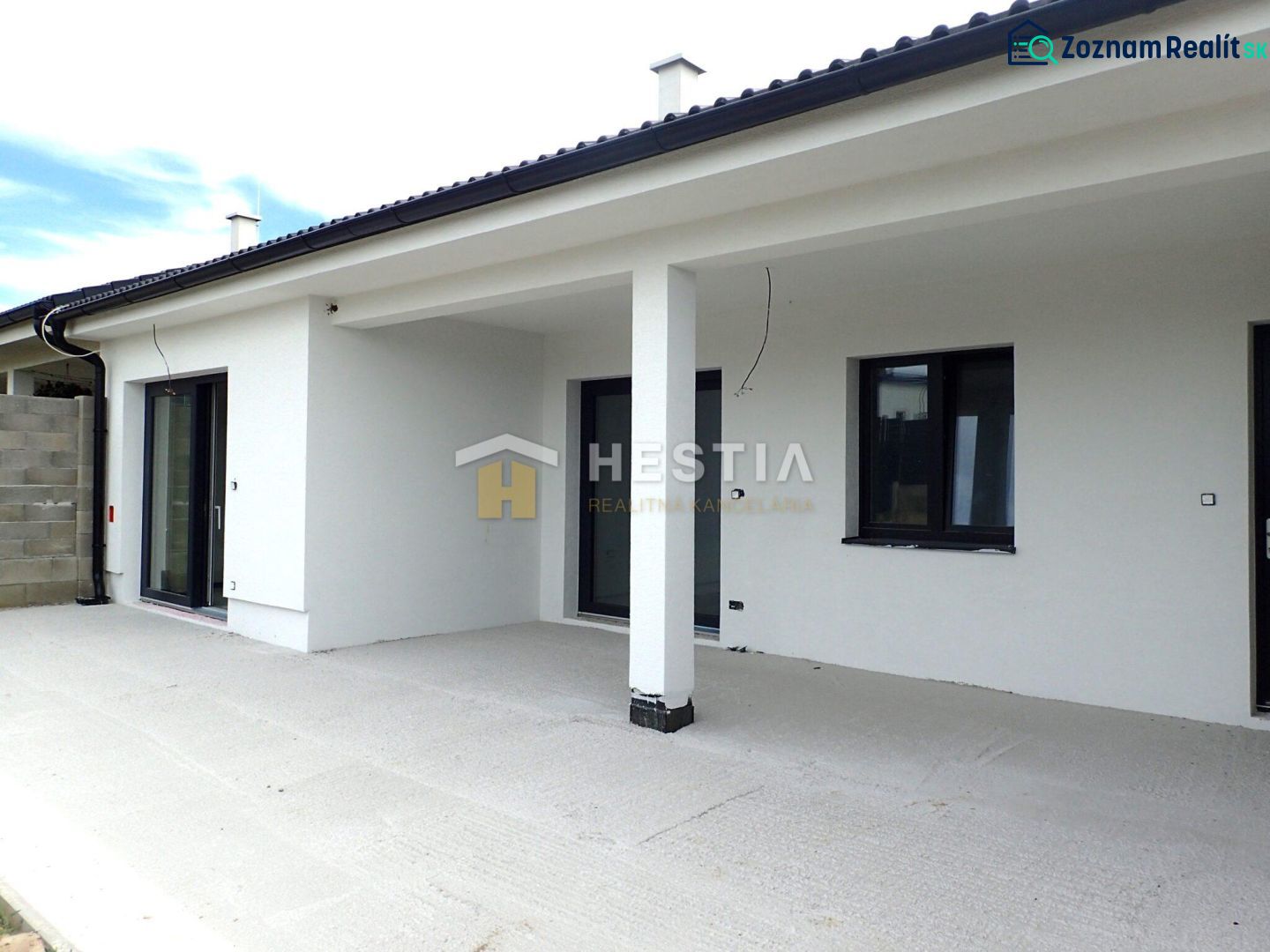 A family house in Hlboké with a light facade and a spacious terrace.