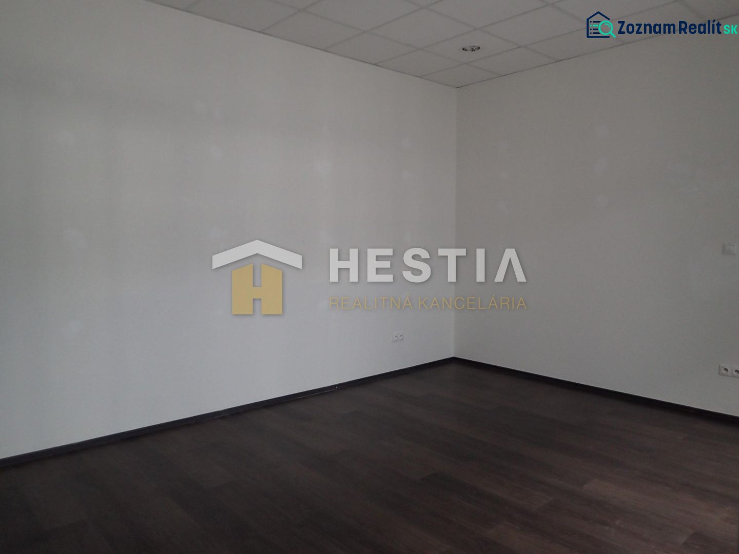 An empty room with a wooden decor floor in a 2-room apartment.