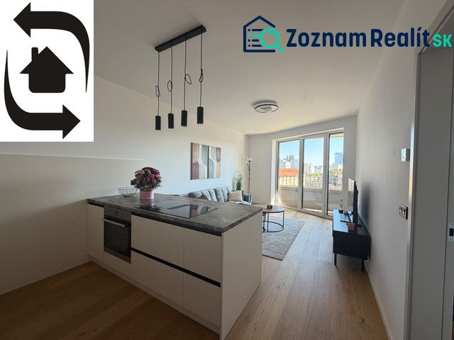 A kitchenette in a 2-room apartment with a wooden decor floor and a view of the city.