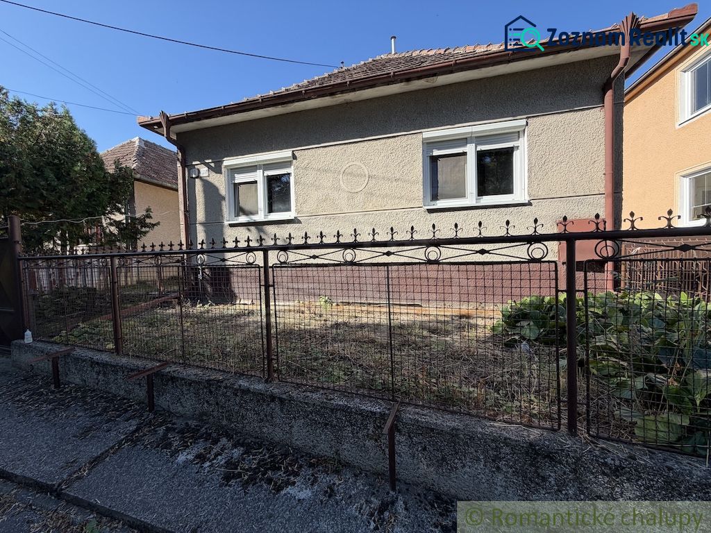 A family house in Tvrdošovce with a small front garden and a metal fence.