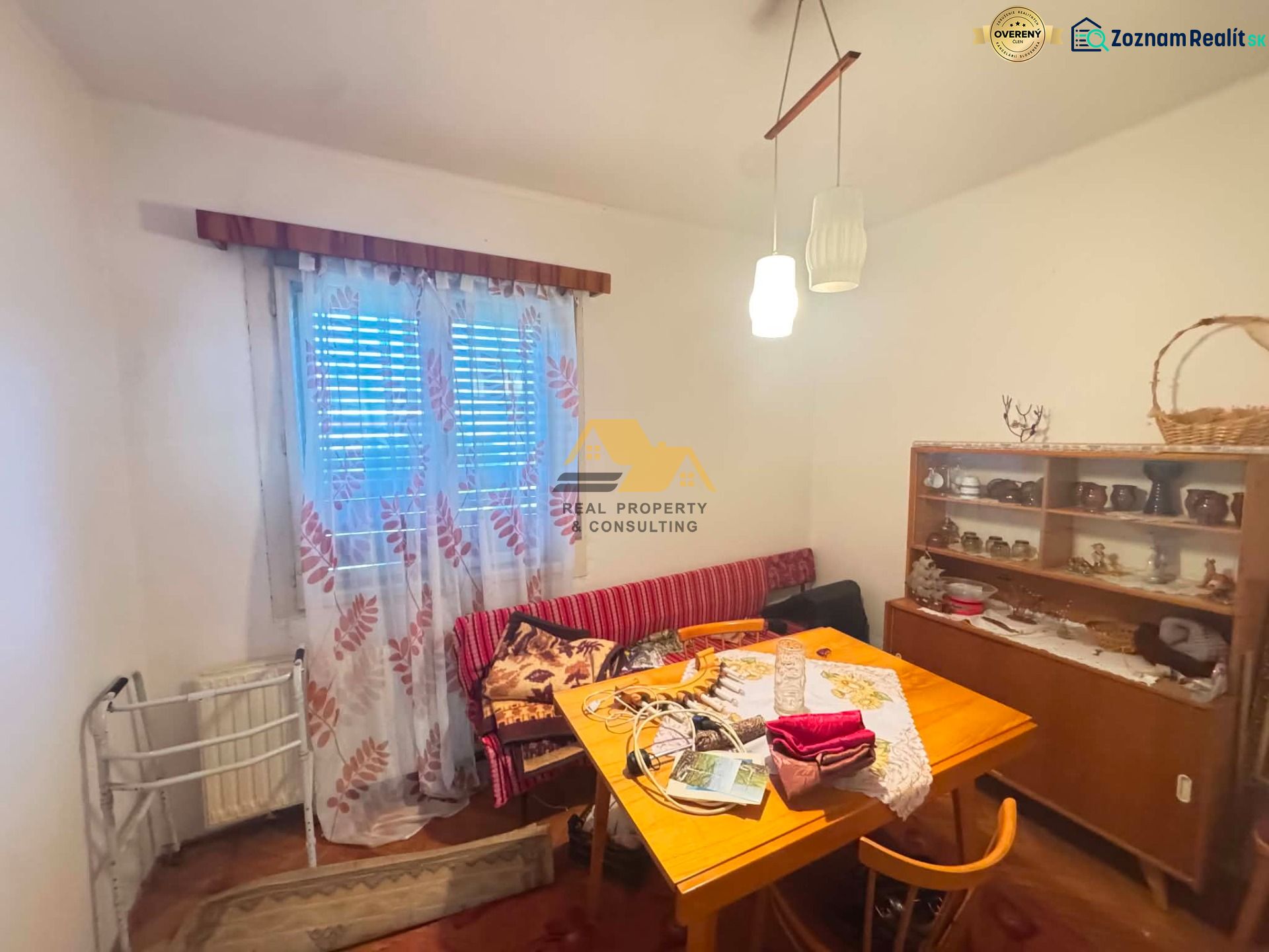 Dining room in a family house with furniture and decorations, wooden decor flooring.