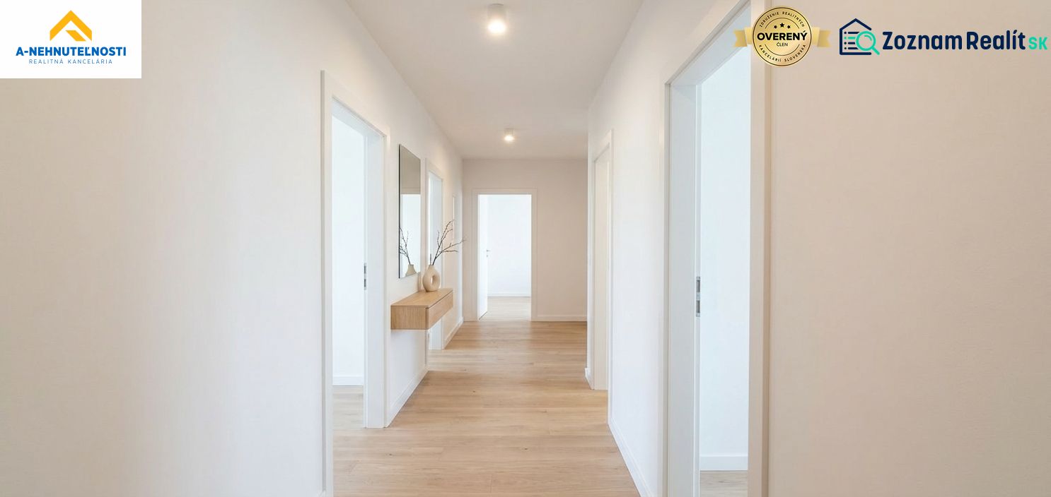 A hallway in a 3-room apartment with a wooden decor floor and decorations on the wall.