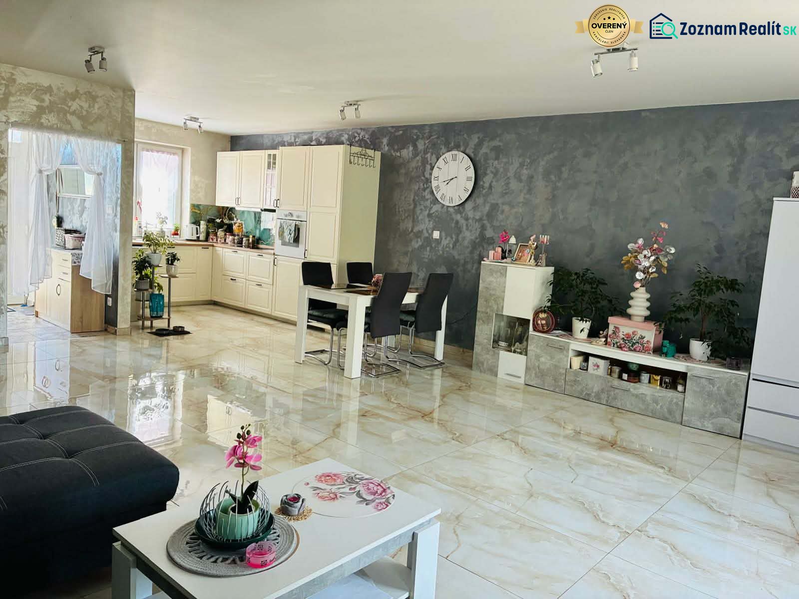 Interior of a family house with a white kitchen, dining table, and decorative elements.