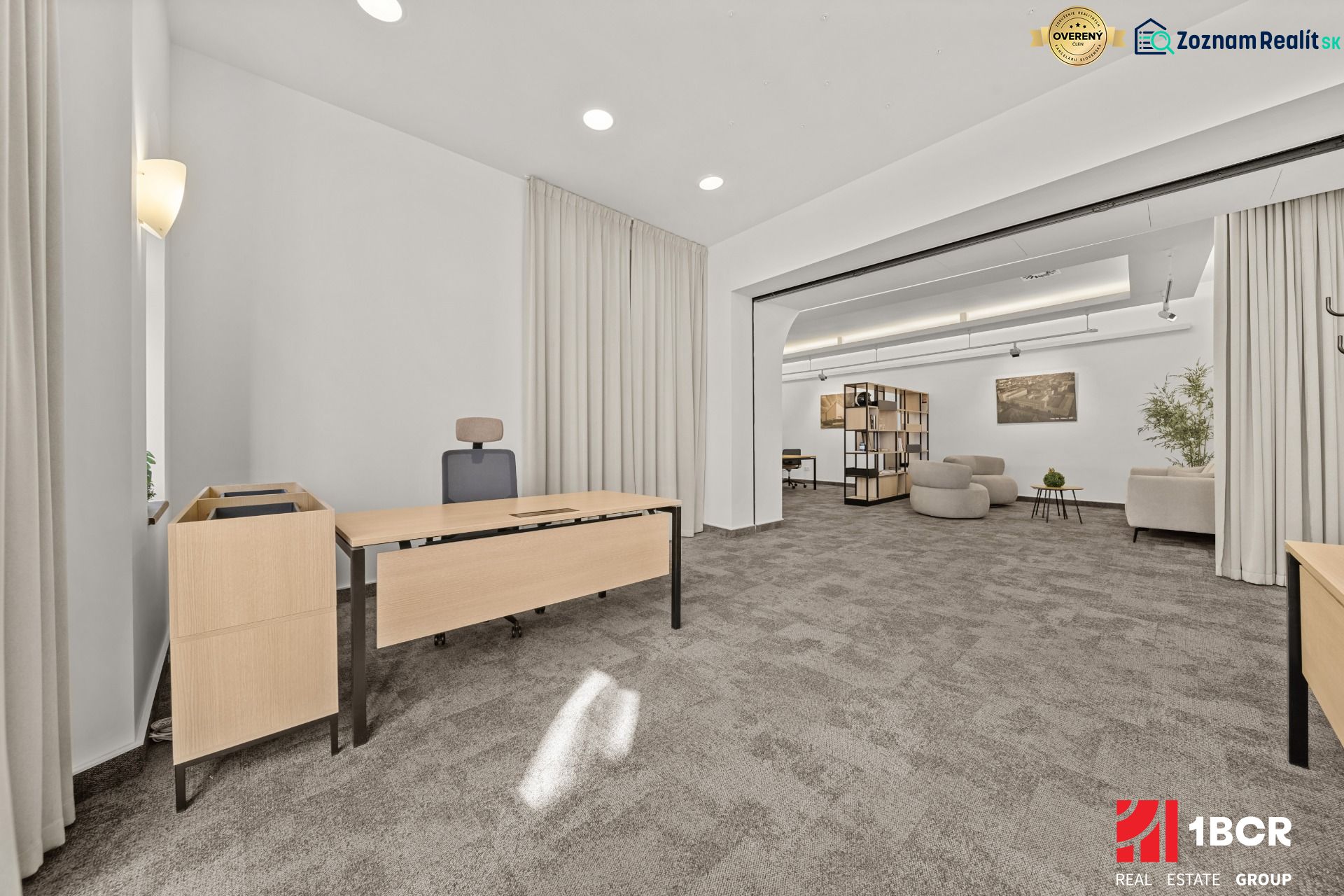 Spacious office spaces with dark flooring and comfortable seating.
