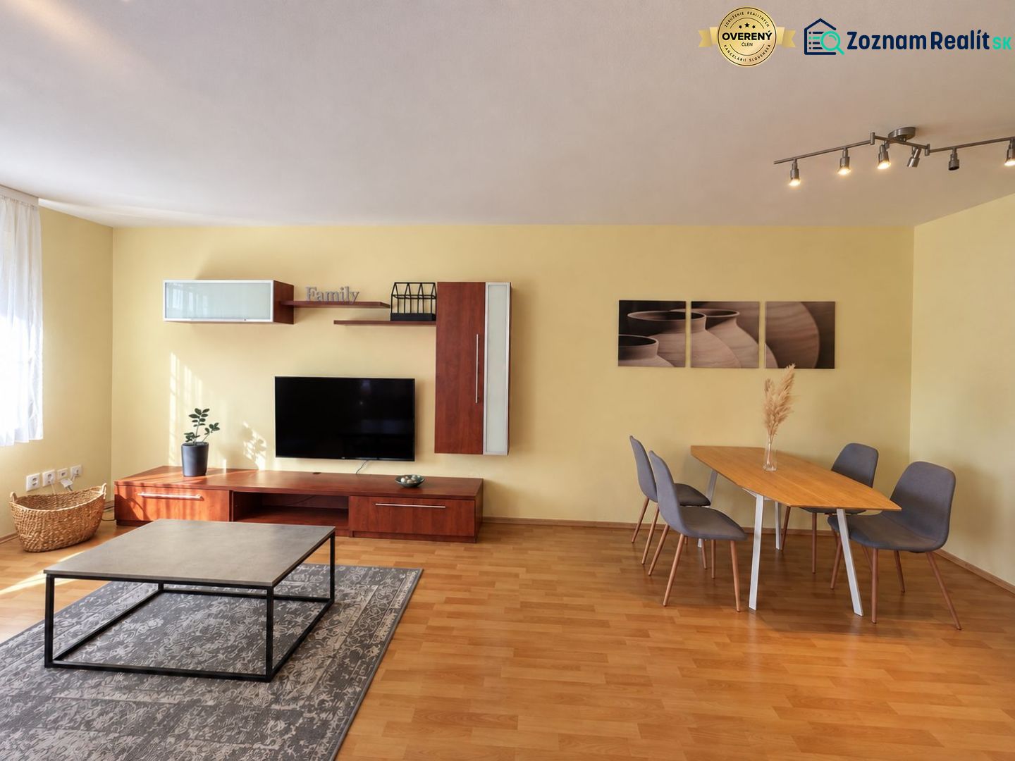 Living room in a 3-room apartment with a wooden decor floor and a dining table.