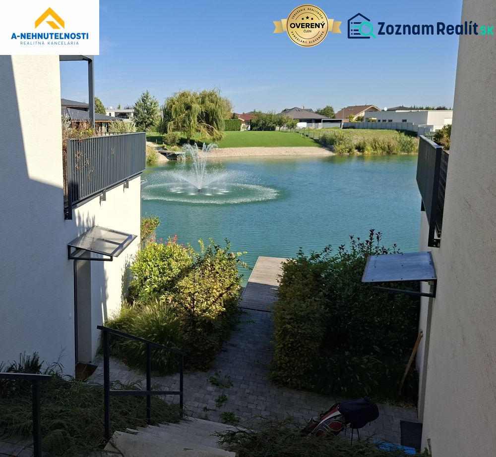 View of the lake with a fountain from the adjacent houses on Golf Street, Hrubá Borša.