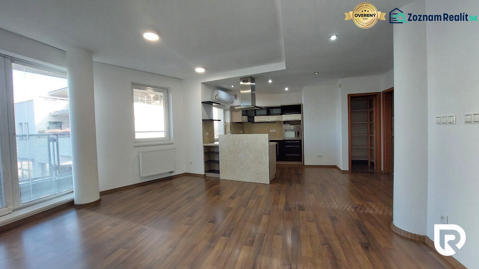 Interior of a 2-room apartment with a kitchen and flooring with a wood decor.