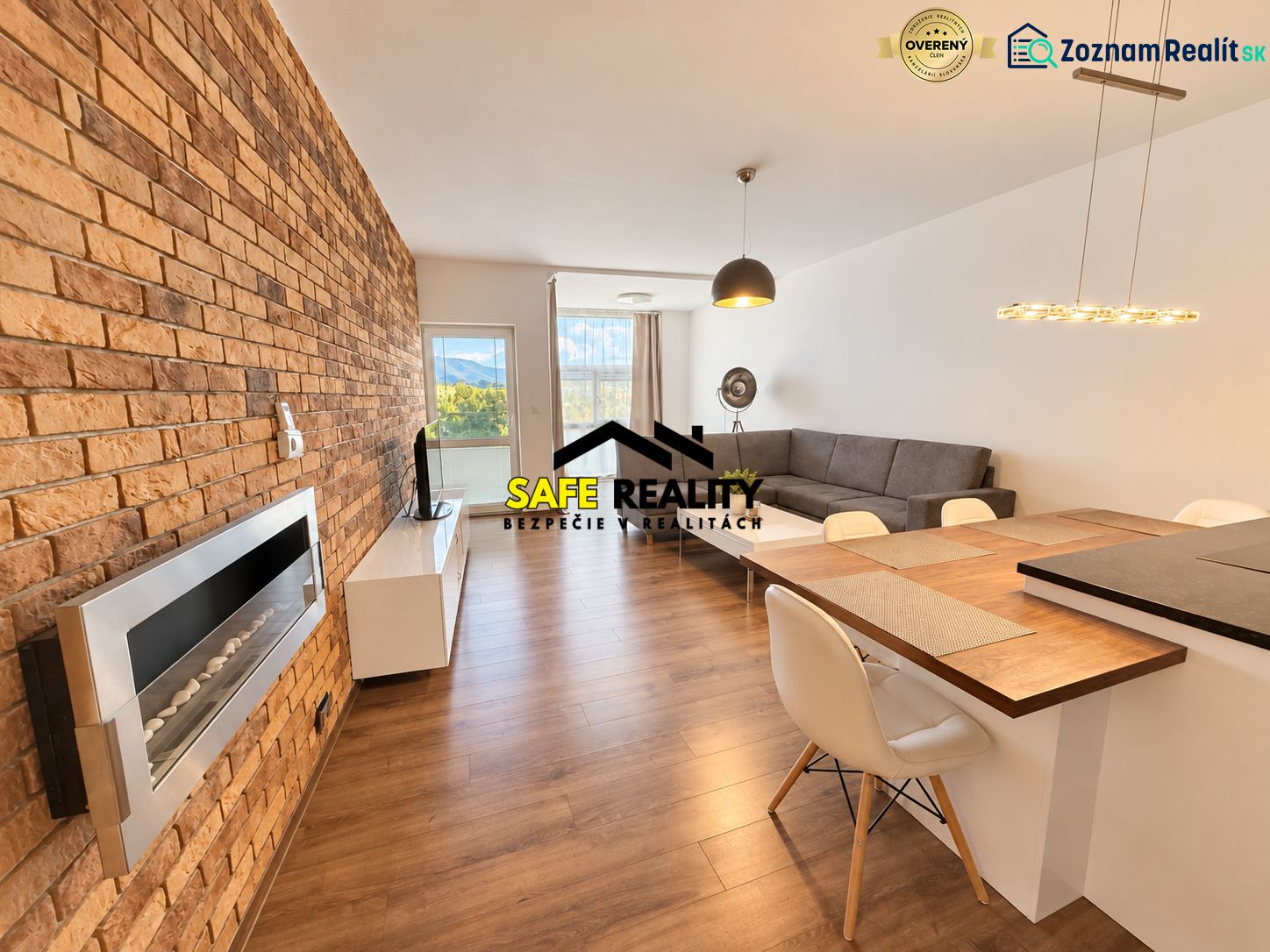 Living room with a brick wall and wood-patterned flooring in a two-room apartment.