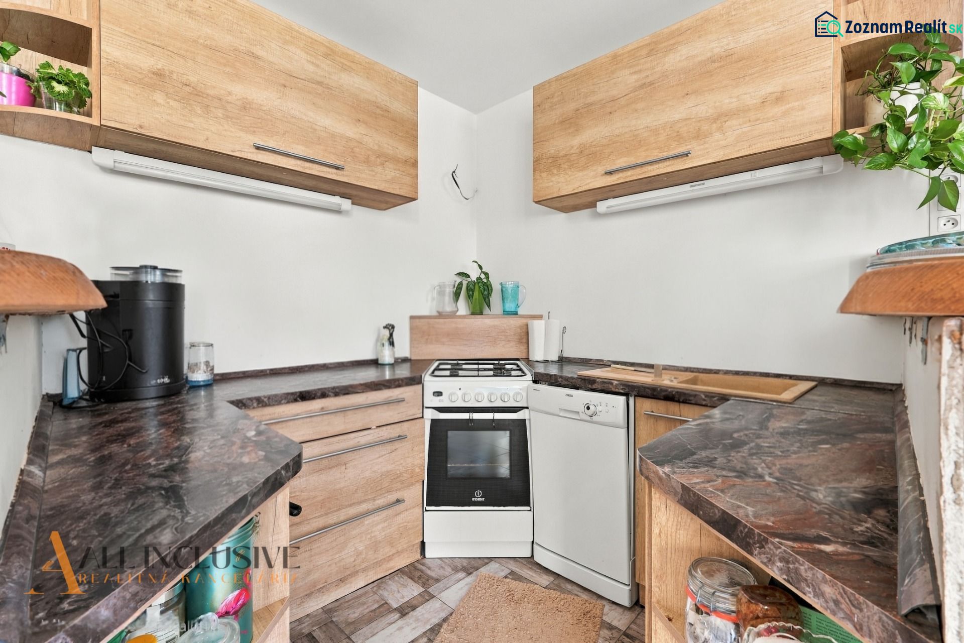 A kitchen with a stove and a dishwasher in a family house.