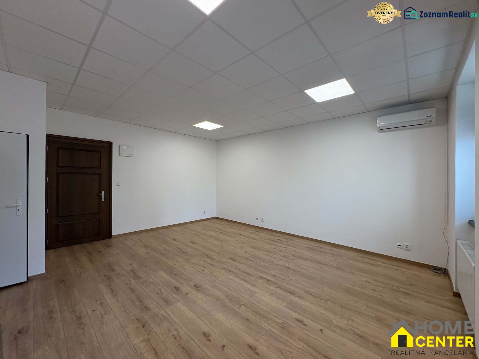 Spacious offices with wood-patterned flooring and white walls.