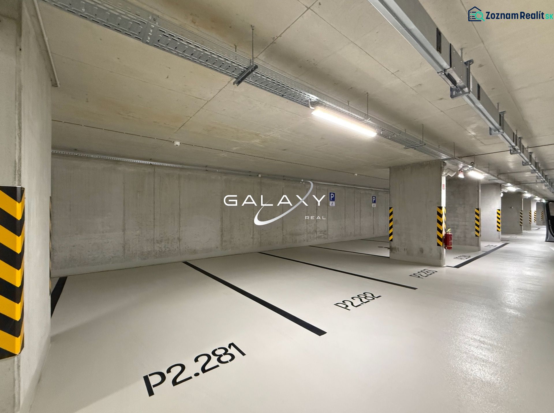 Parking spaces in indoor garages with numbering on the concrete floor.