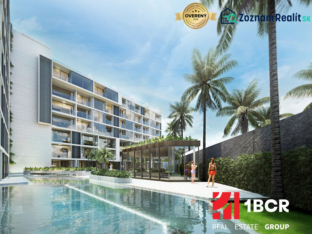 Apartment construction in Phuket with a pool and palm trees in the background.
