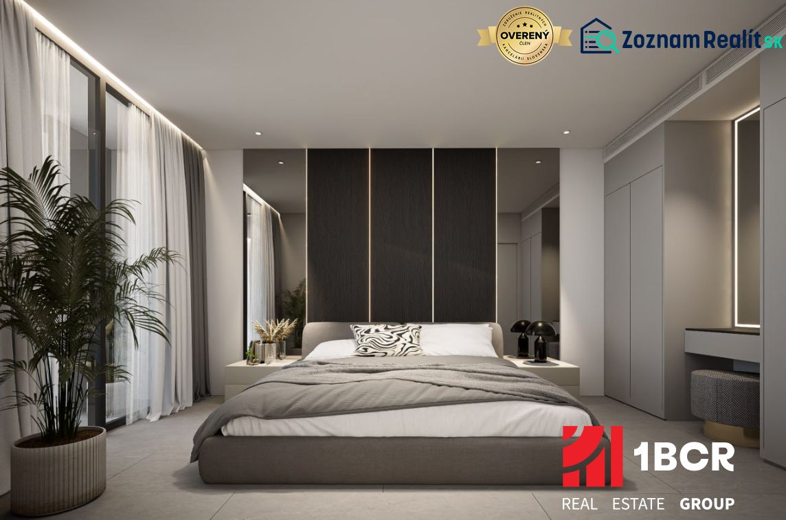 Bedroom in a 2-room apartment with a large bed and decorative lighting.