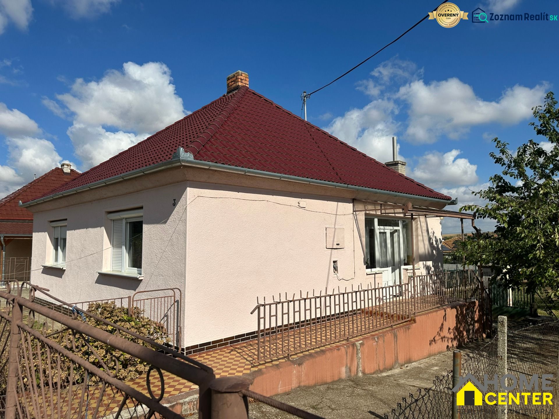 A family house on Cintorínska Street in Dulovce with a red roof and fence.
