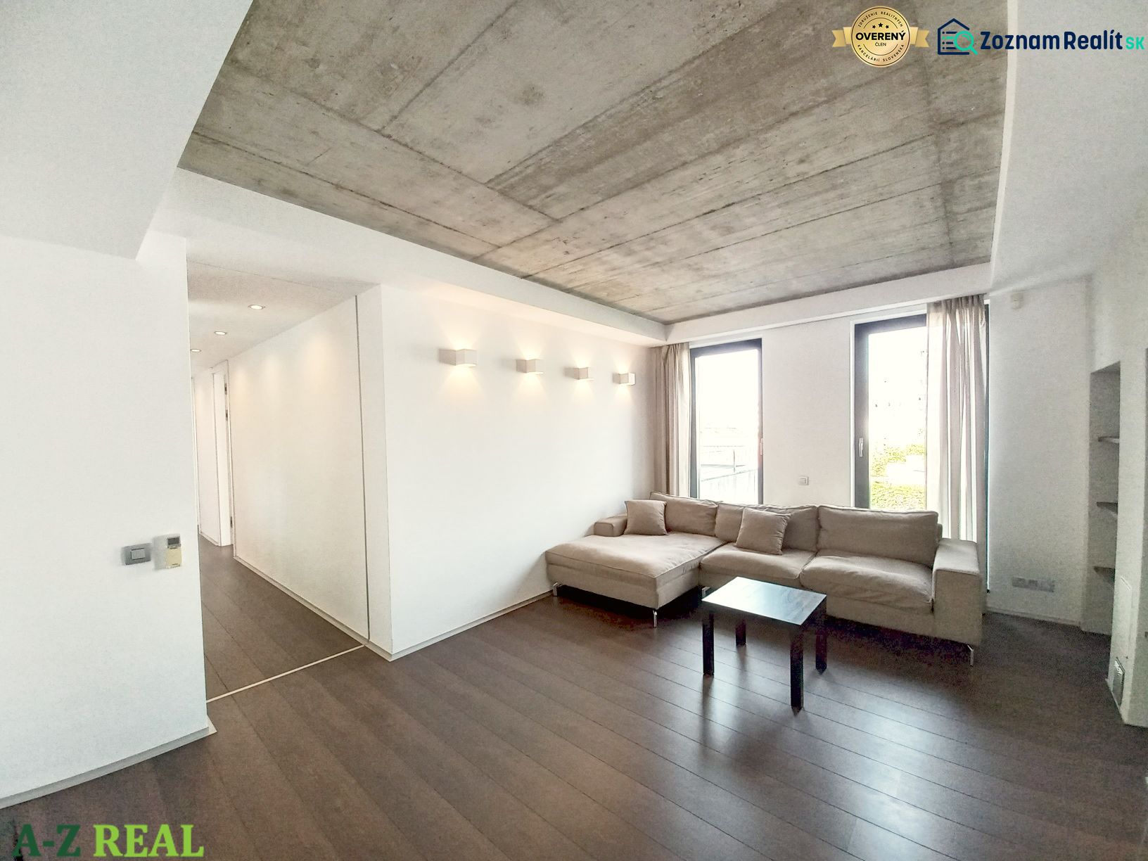 Living room in a 4-room apartment with a sofa, coffee table, and floor with a wooden decor.