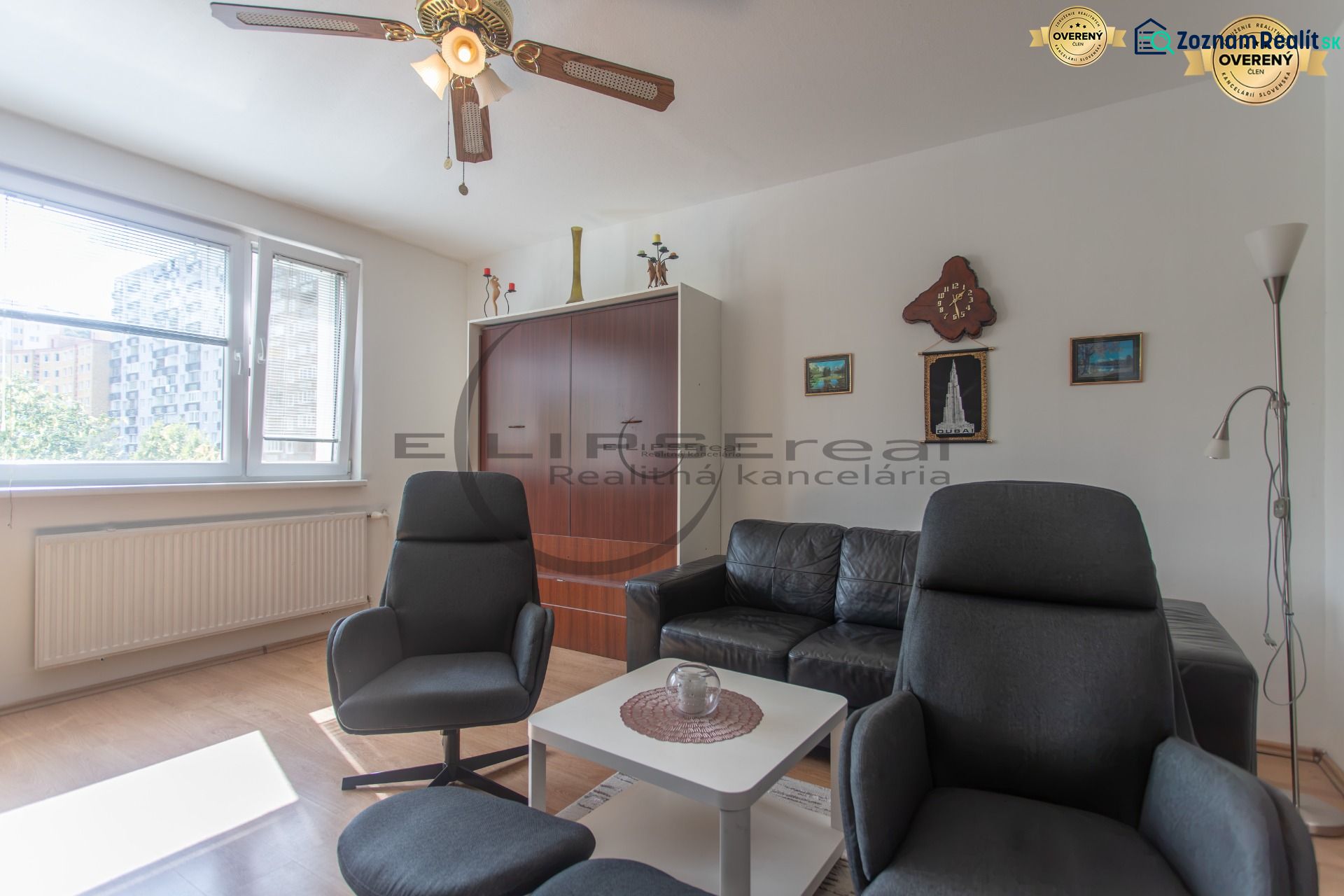 Living room with comfortable seating and wooden decor flooring in a 3-room apartment.