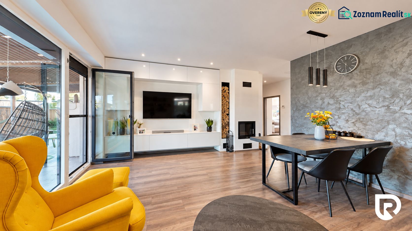 Living room in a family house with a wood-patterned floor and a yellow armchair.