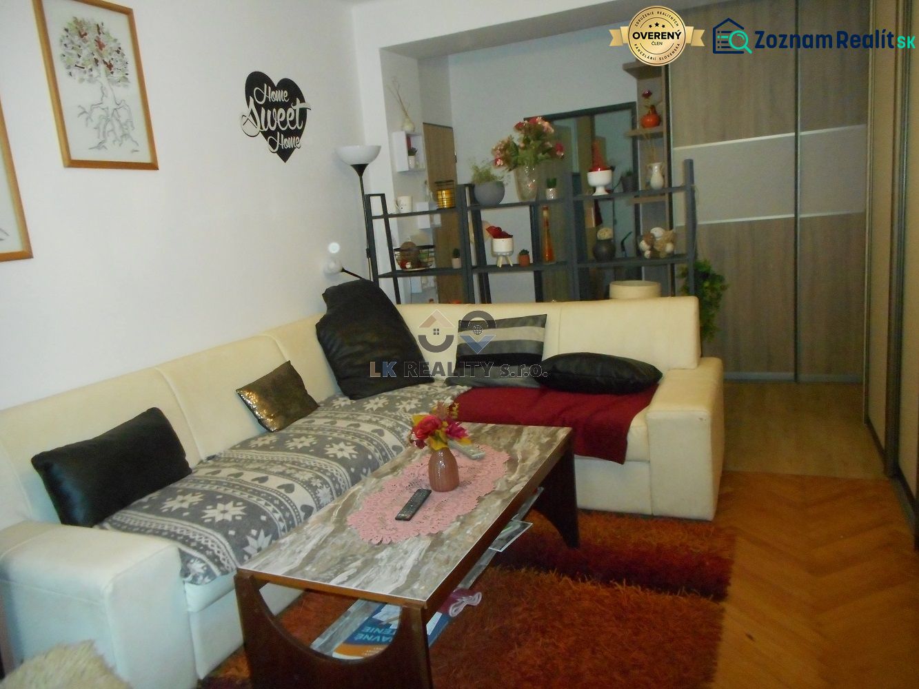 Living room with a sofa, coffee table, and wooden decor flooring in a two-room apartment.