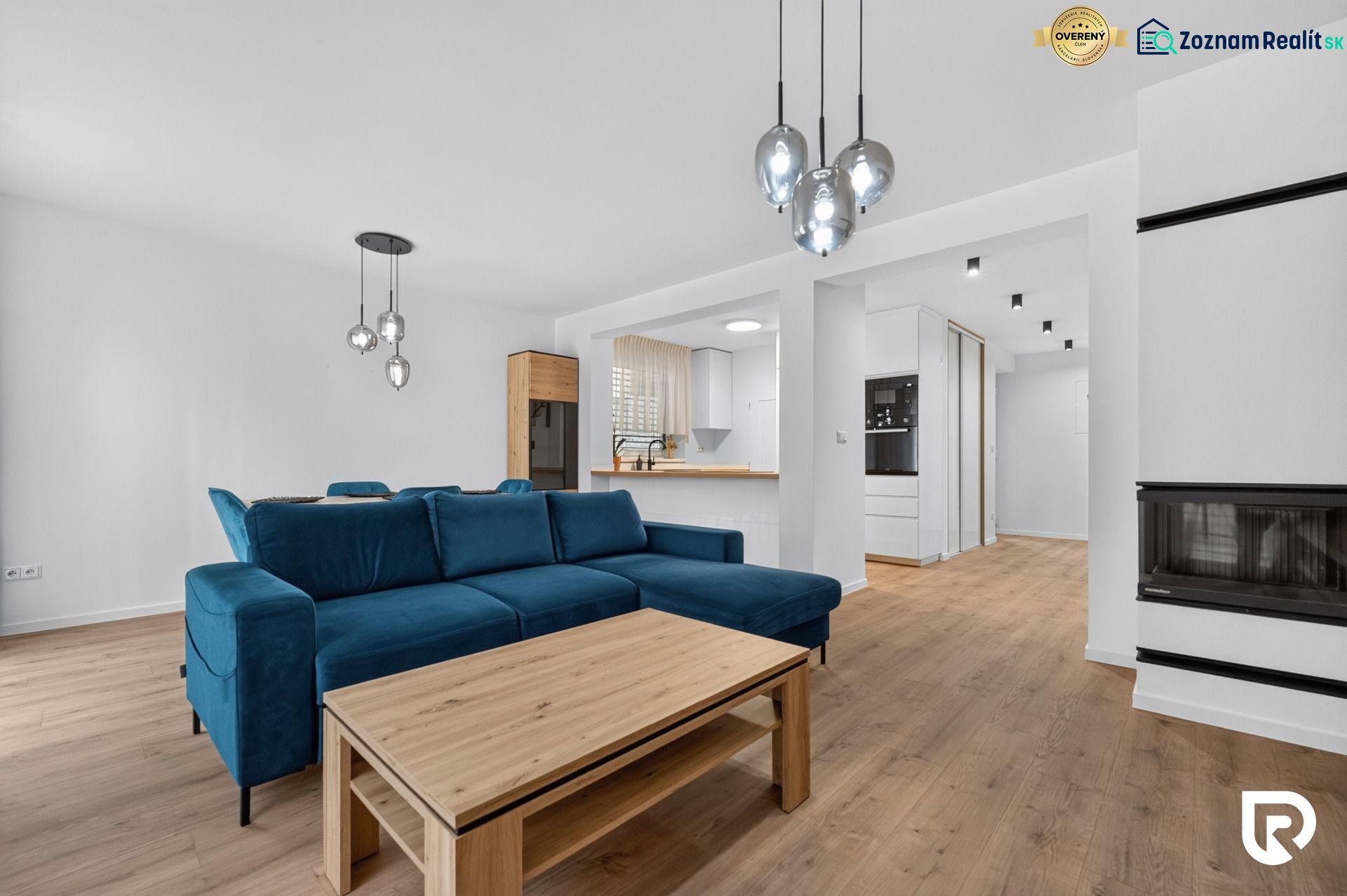 Living room in a family house with a blue sofa and a wooden decor floor.