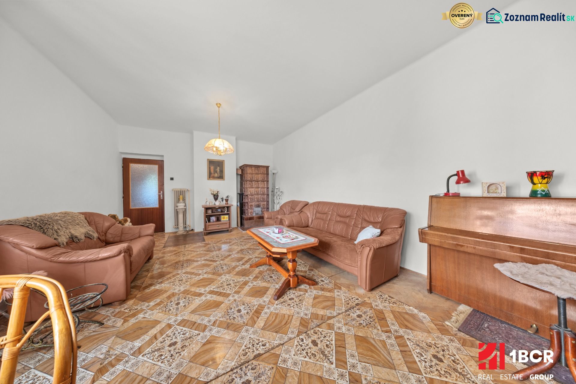 Living room in a family house with a leather sofa, piano, and wooden decor flooring.
