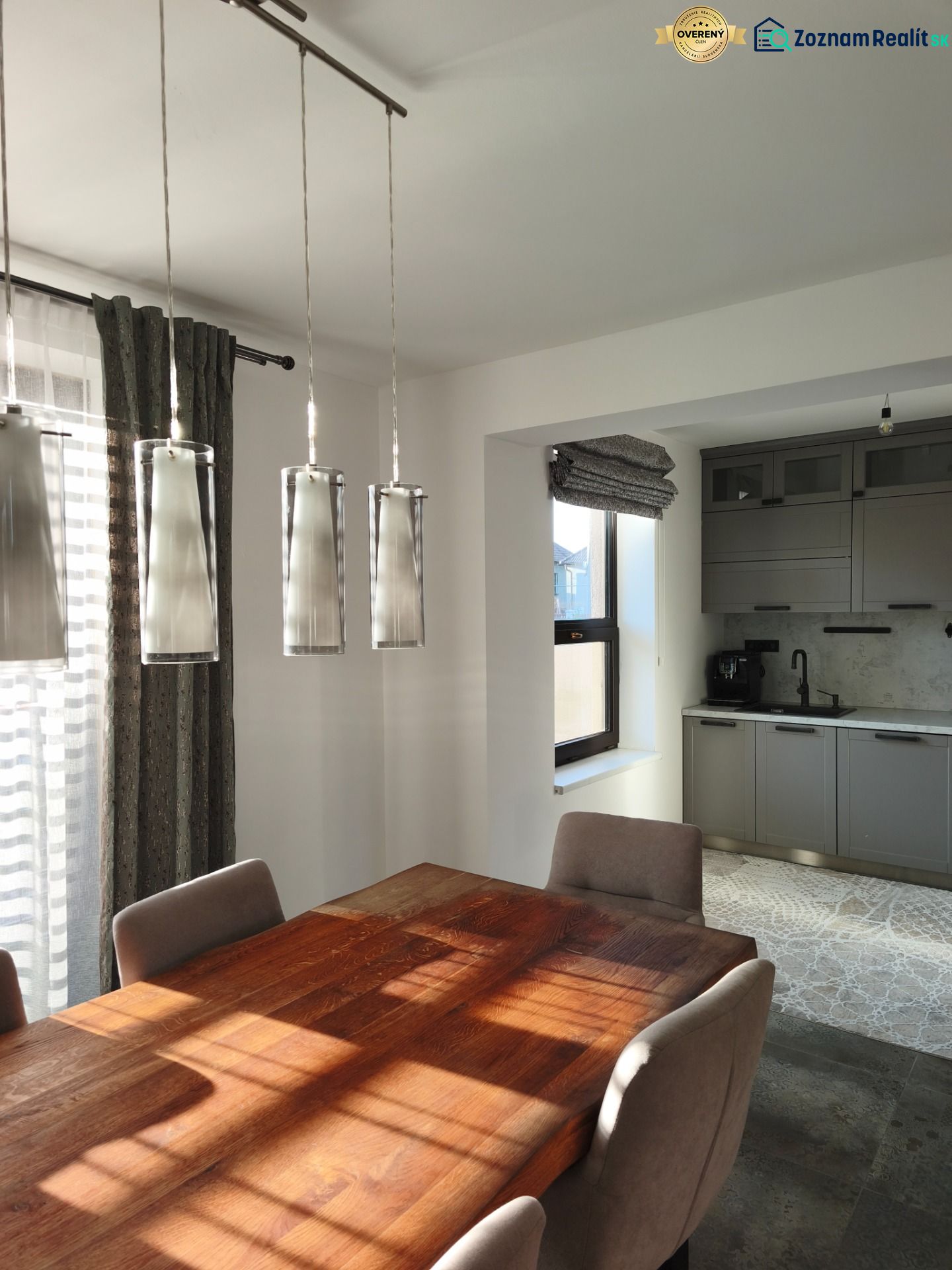 Dining table with wood decor and gray cabinets in a family house.