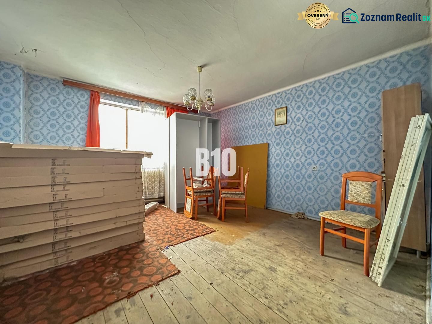 The interior of a family house with furniture and blue wallpaper on the walls.