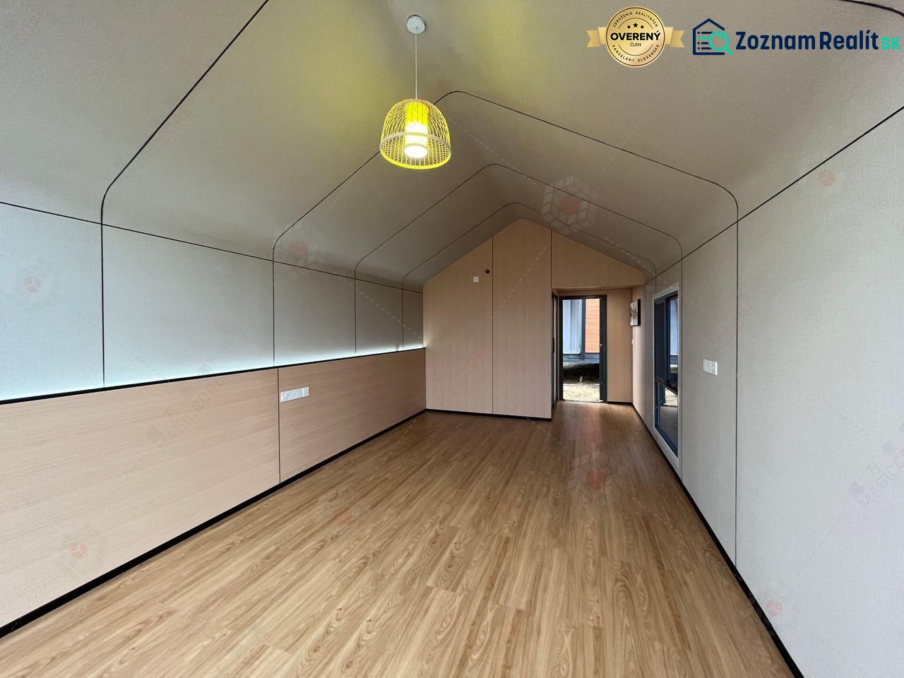 Interior of a cabin with a wood-patterned floor and an impressive pendant light.