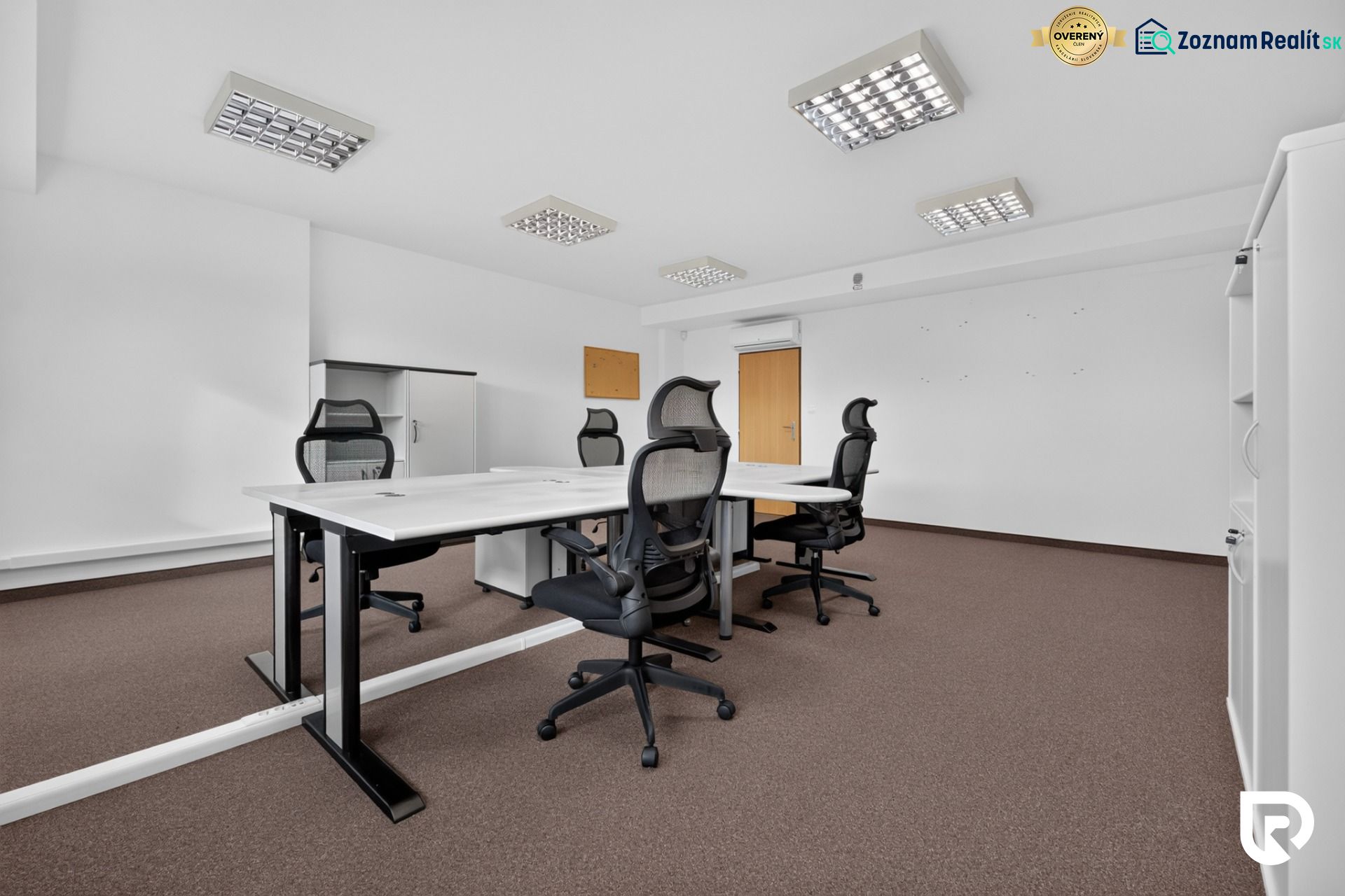 Offices with a conference table, ergonomic chairs, and storage cabinets.