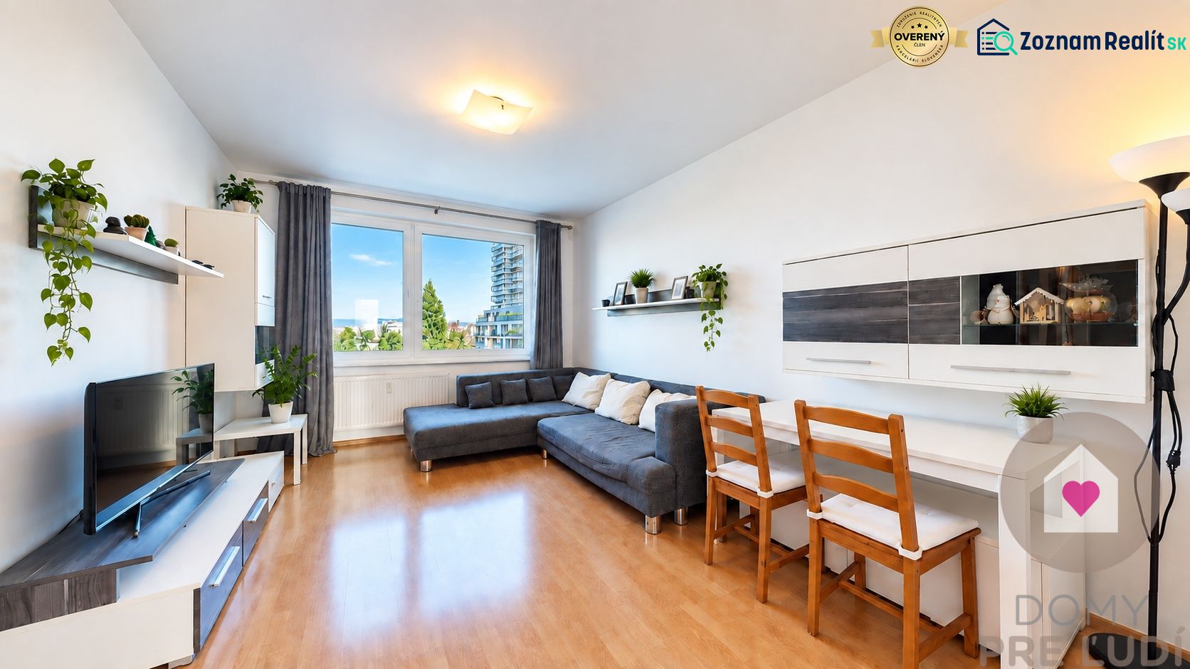 Living room with a sofa and TV, 3-room apartment, floor with wood decor.