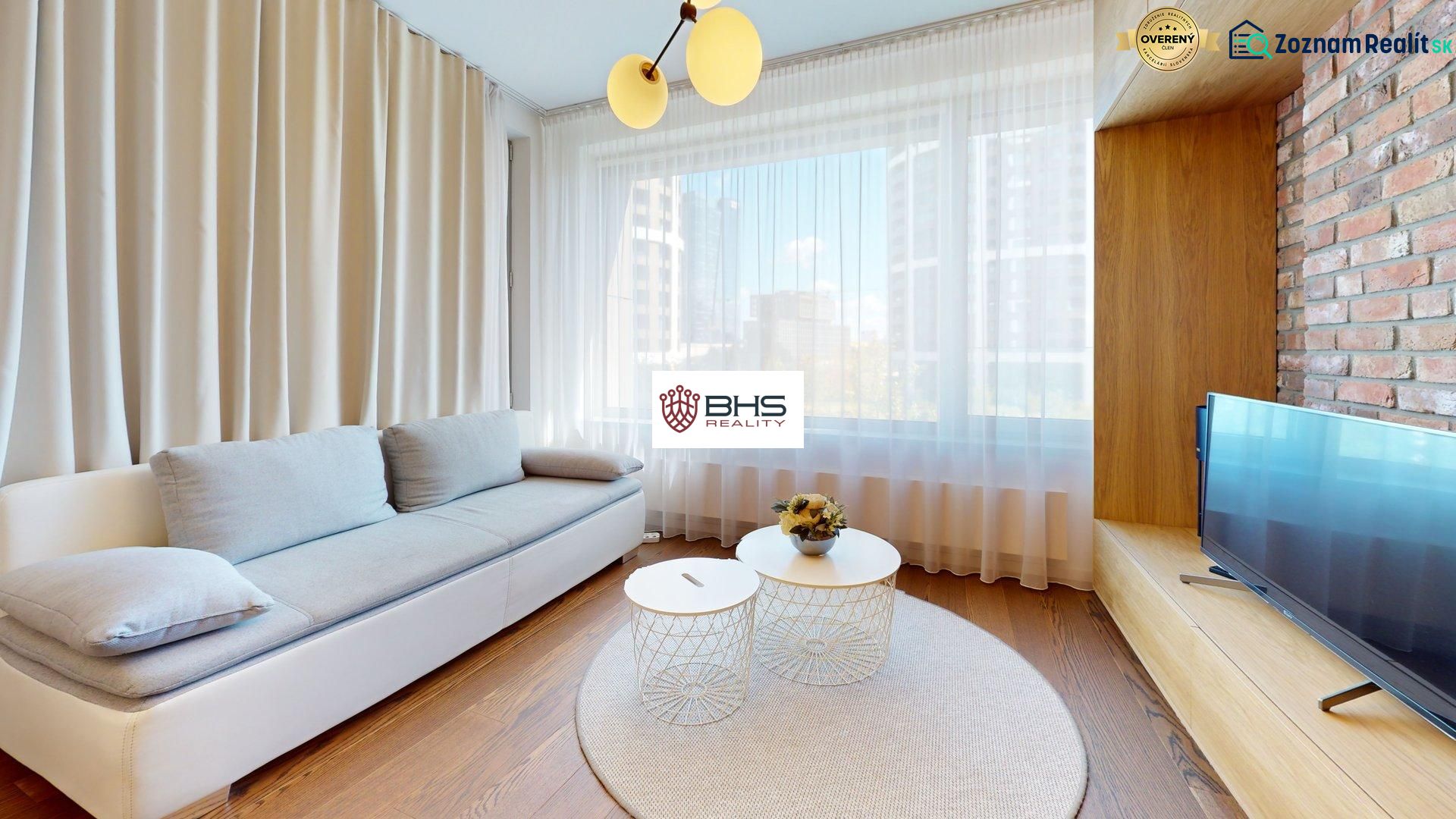 Living room in a two-room apartment with a wooden-patterned floor and stylish furniture.