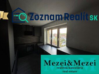 A kitchen in a 2-room apartment with dark furniture and a view from the window.