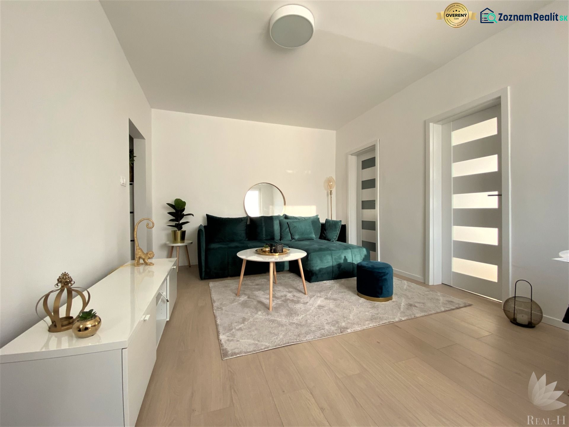 Living room with a sofa and decorations in a 3-room apartment, bright interior.