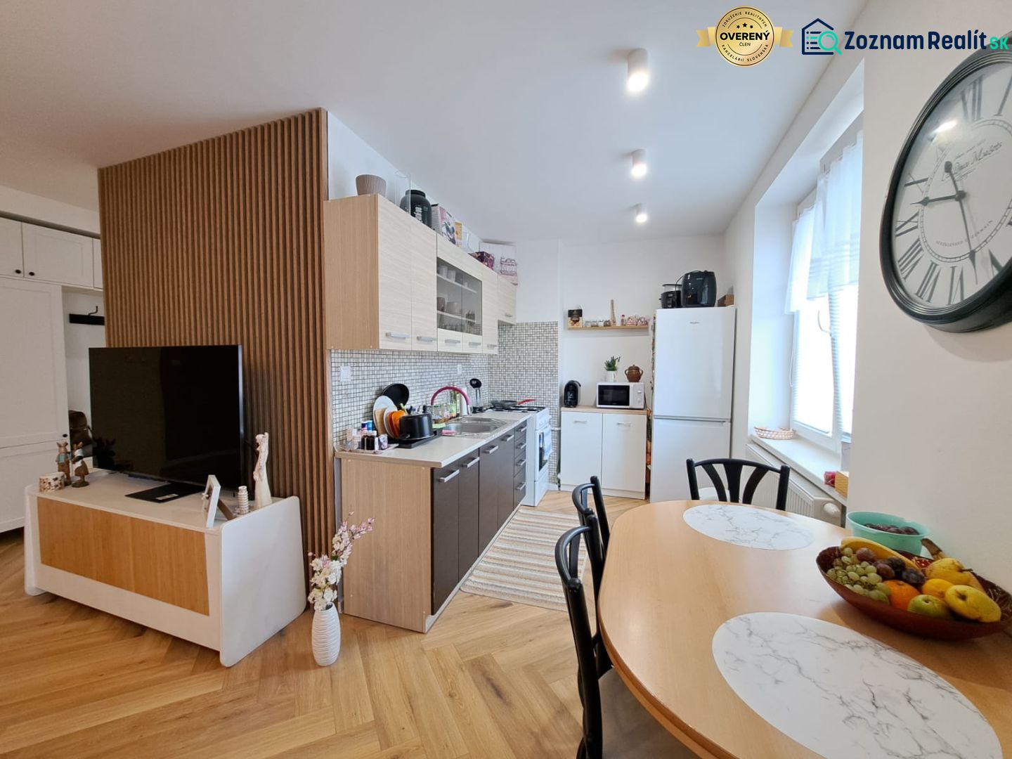 Kitchen and dining room in a 3-room apartment with a wooden decor floor.