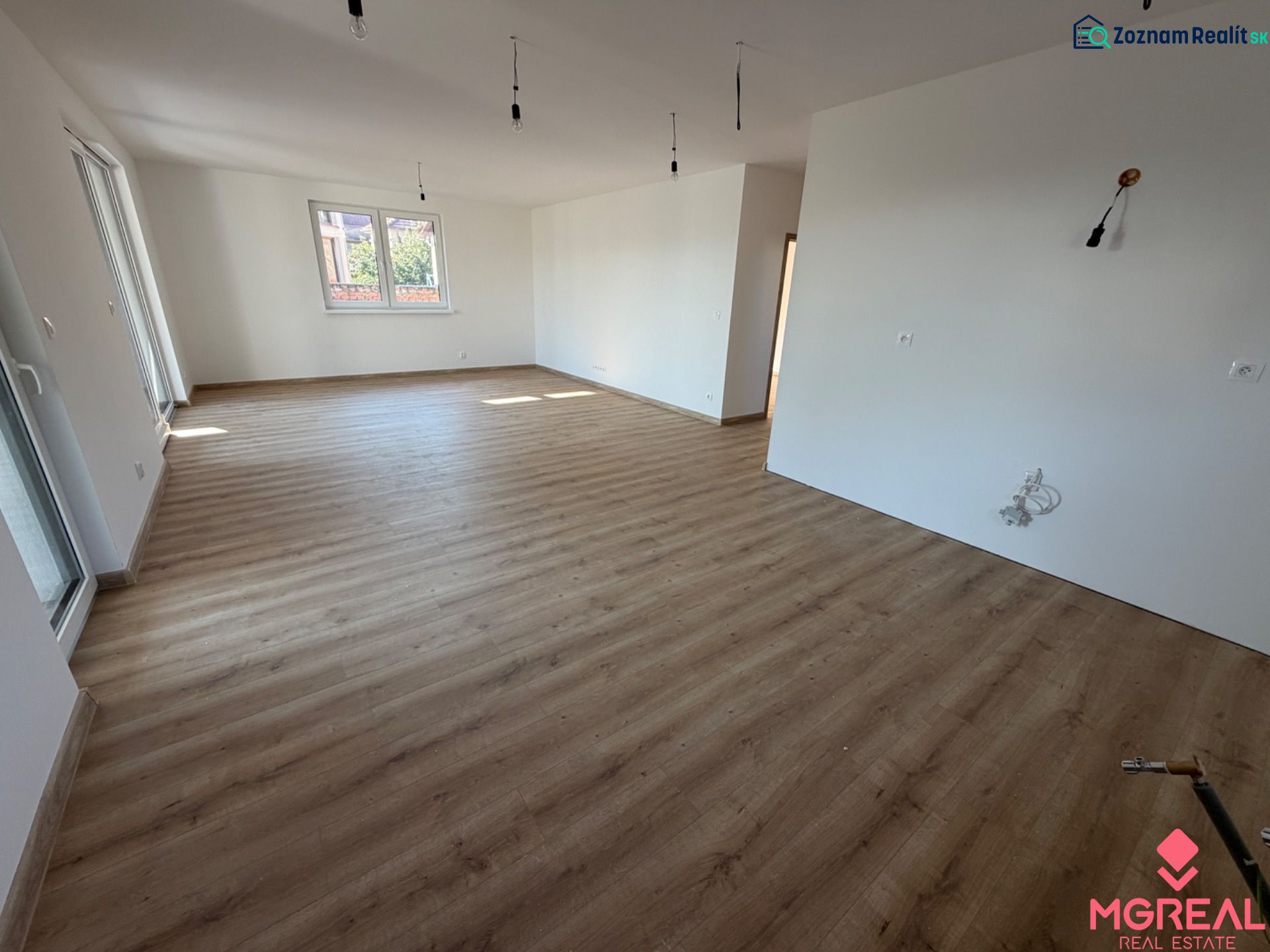 Interior of a family house with a wooden decor floor and white walls.