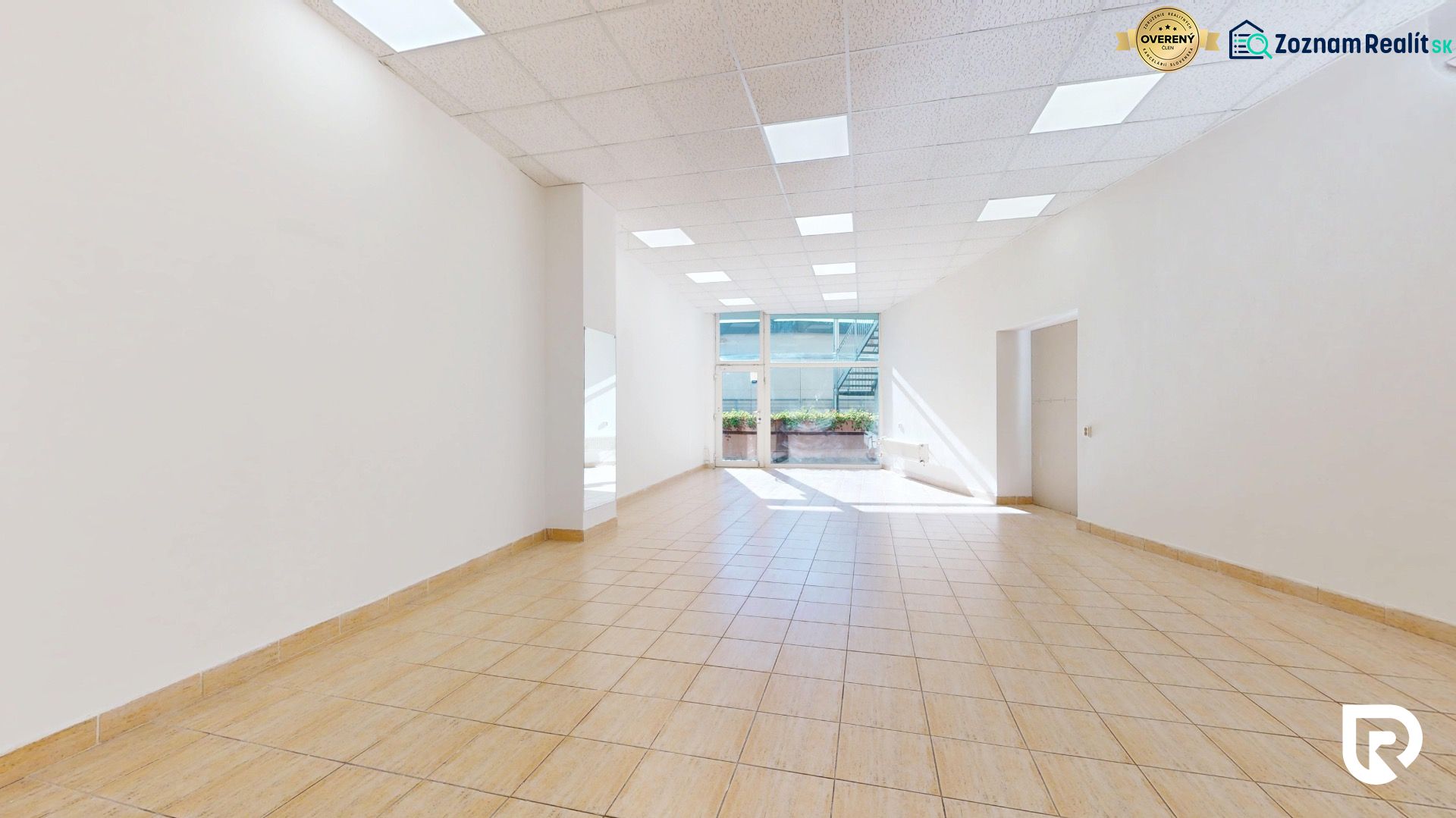 Spacious commercial spaces with tiles and large windows that let in natural light.
