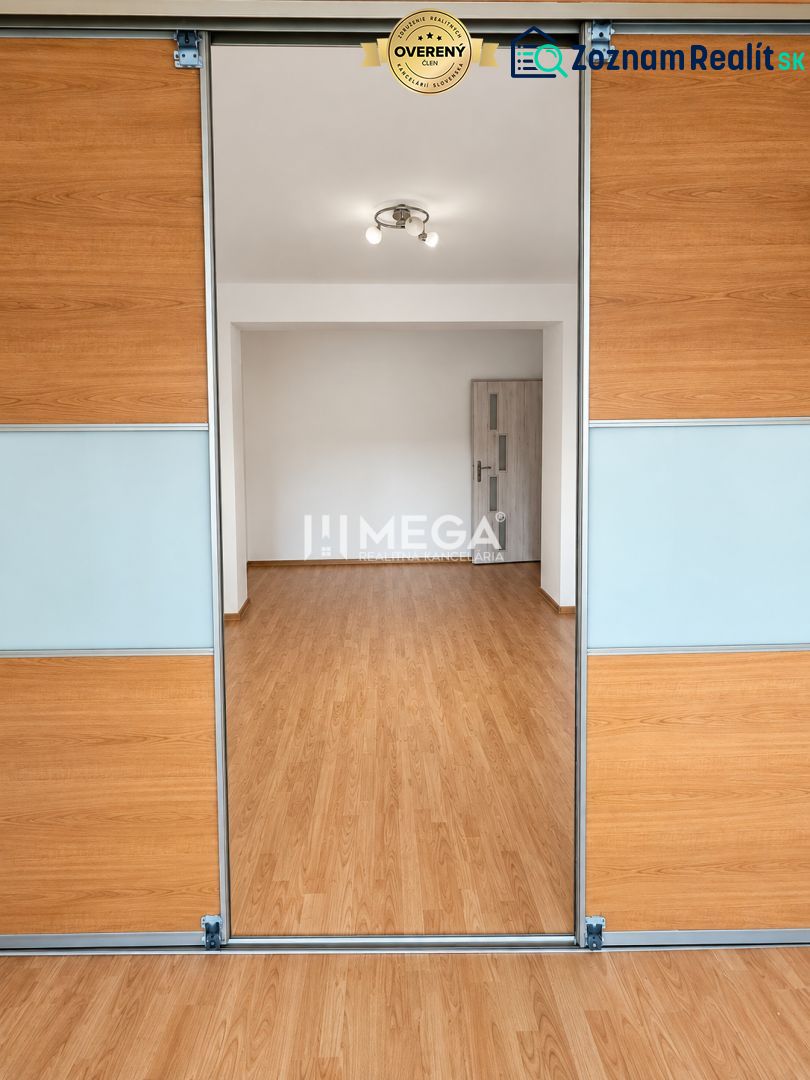Interior of a 2-room apartment with doors and flooring featuring a wood design.