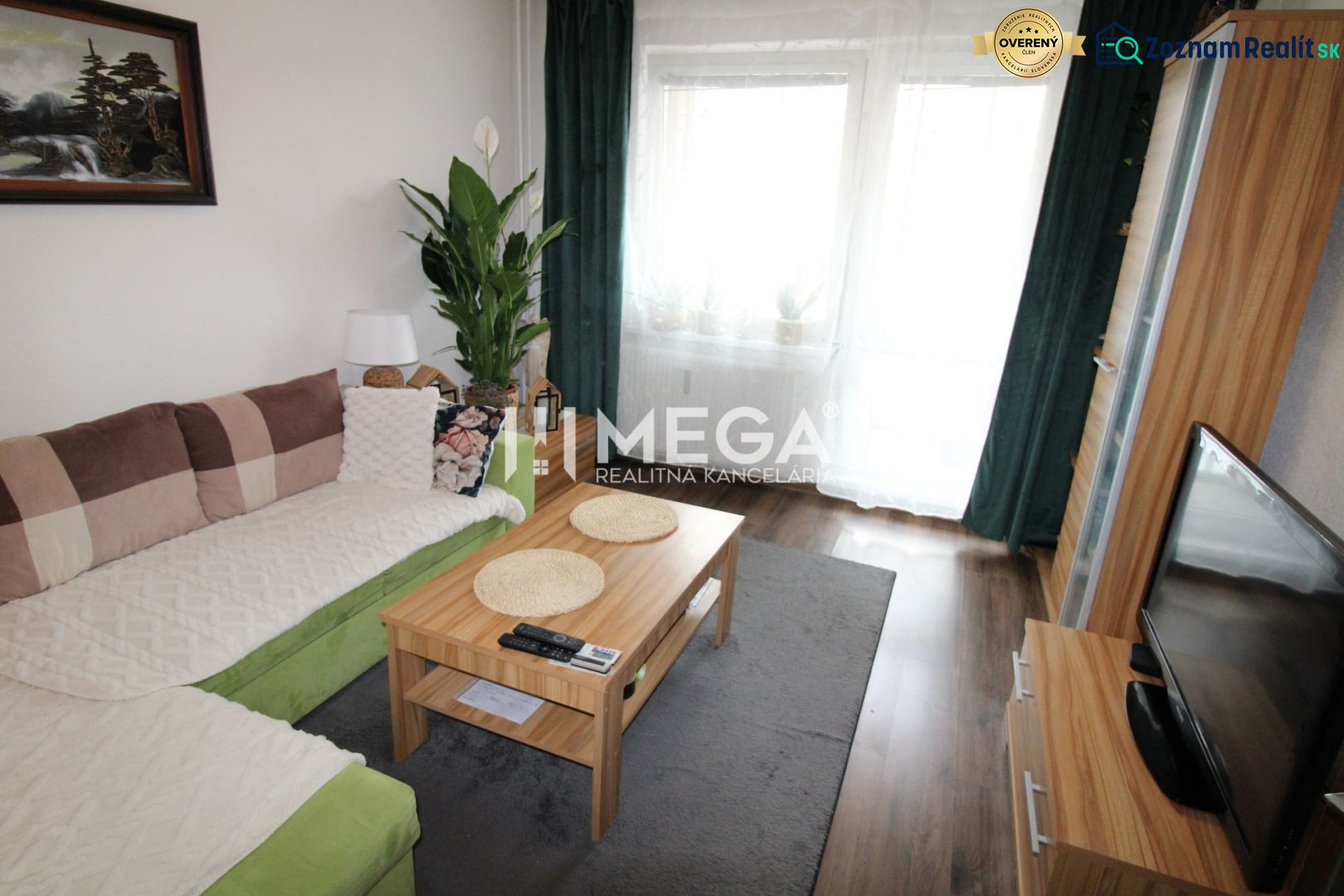 Living room in a 3-room apartment with a sofa, table, and wooden decor flooring.