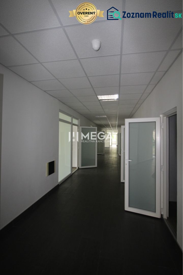 Offices with white walls, dark floors, and bright glass doors.