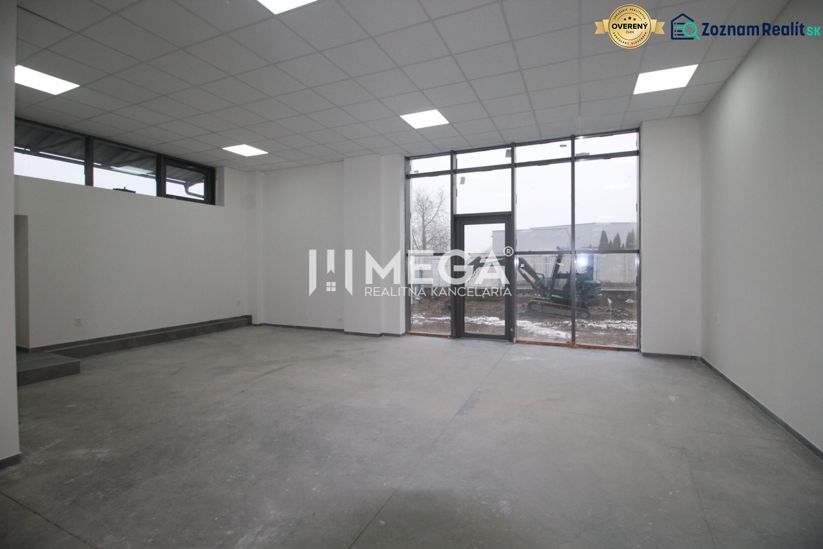 Interior of commercial spaces with large windows and frosted ceiling lights.