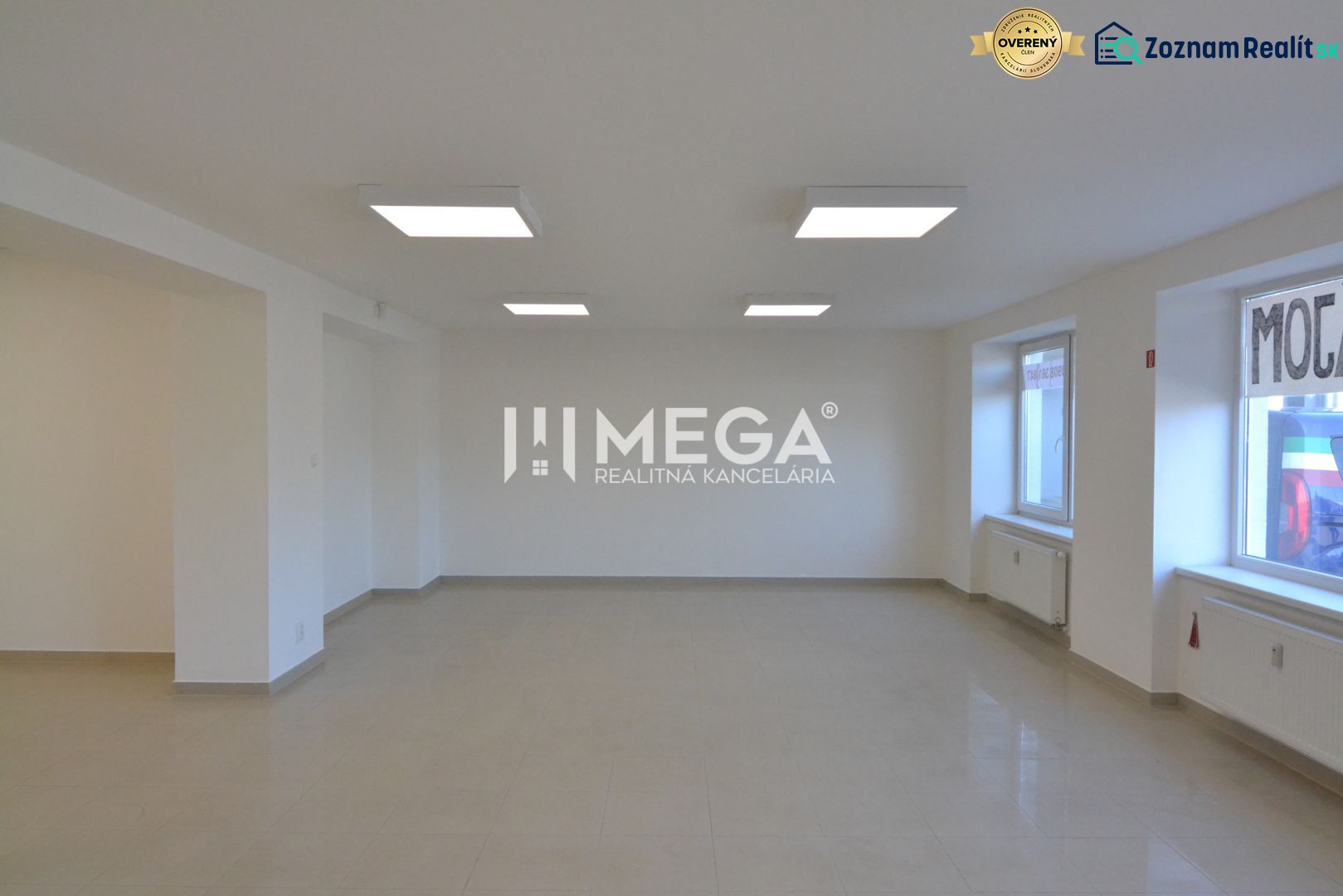 Interior of commercial spaces with ceramic flooring and large windows for natural light.