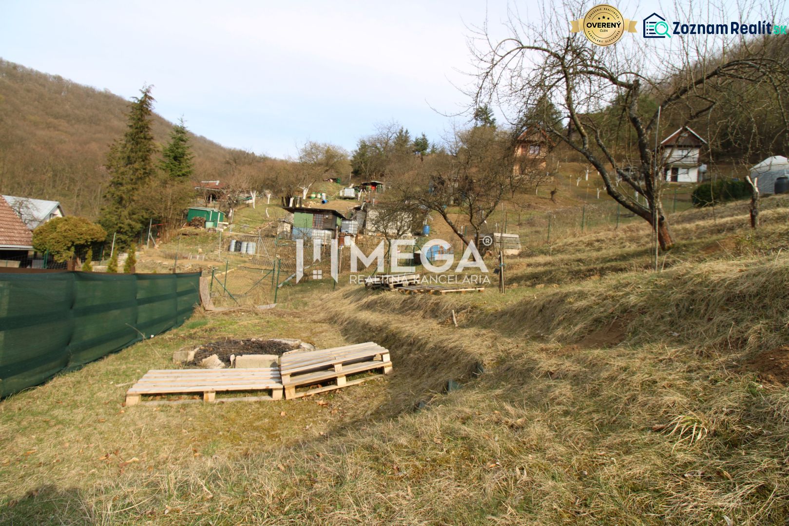 Gardens on ZO Poniklec Street in Humenné with several trees and wooden pallets.